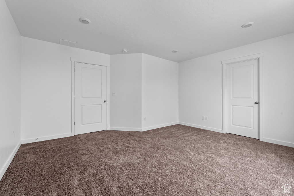 Empty room with carpet and baseboards