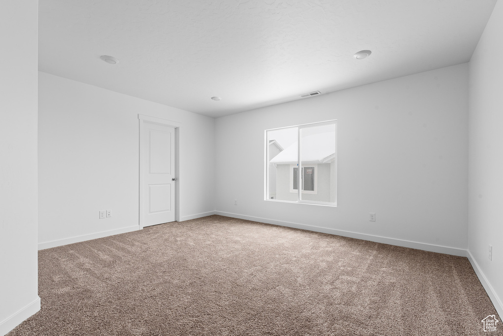 Empty room with carpet floors and baseboards