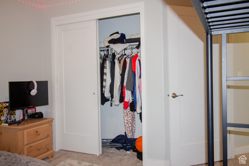 Bedroom featuring carpet and a closet