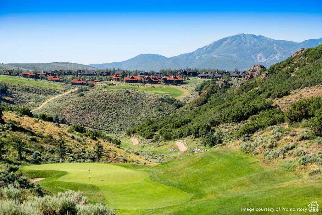View of mountain backdrop with a golf course