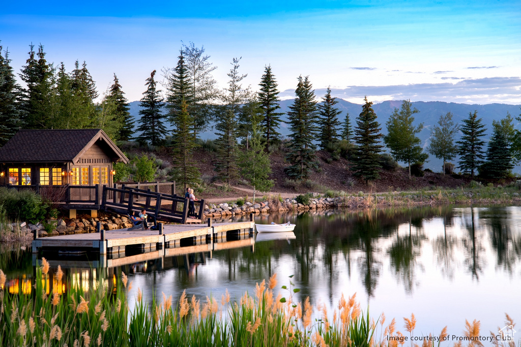 Water view featuring a boat dock and a mountain backdrop