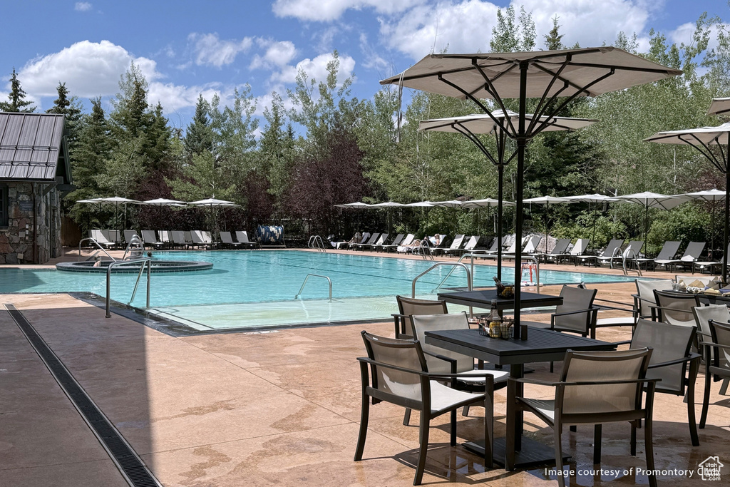 Community pool featuring a patio