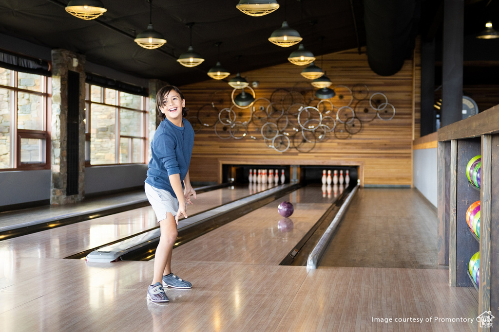 Rec room with a bowling alley and wood finished floors