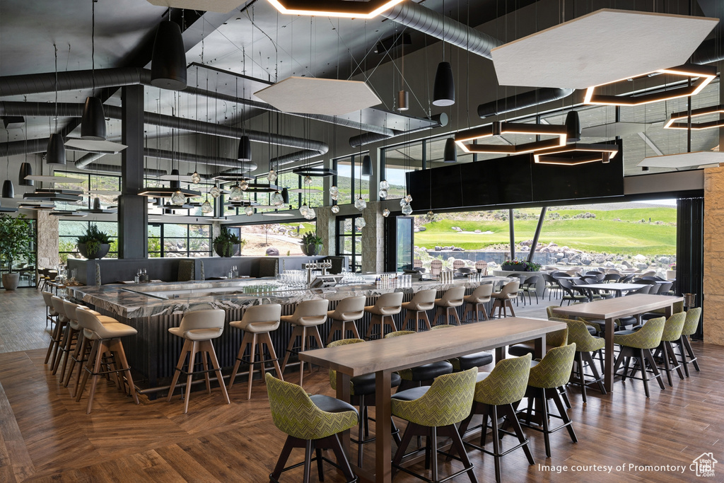 Dining area featuring a towering ceiling and a community bar