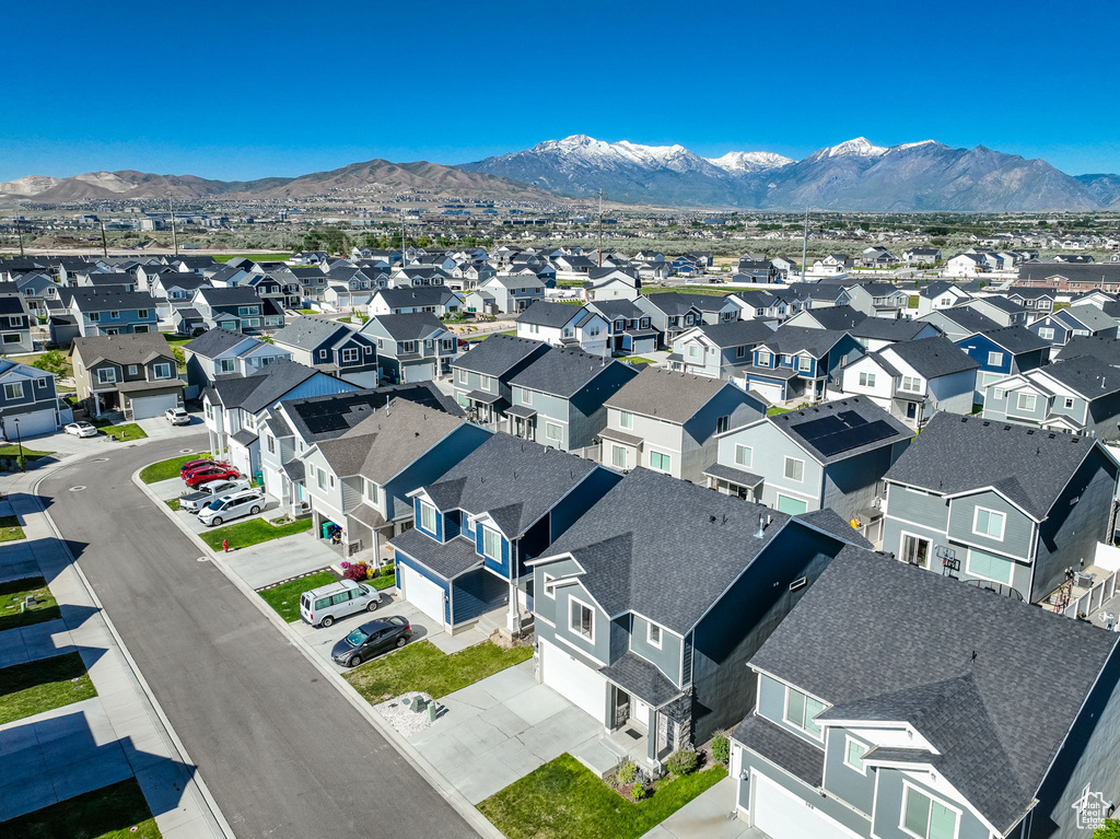 Aerial perspective of suburban area with a mountainous background