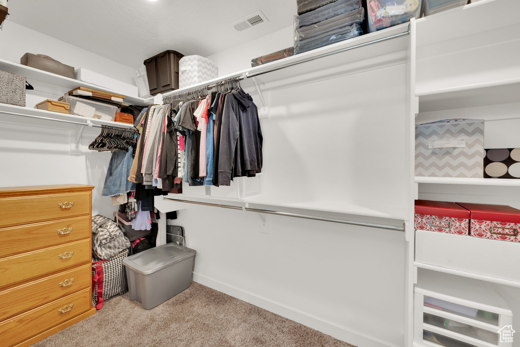 Walk in closet with carpet flooring