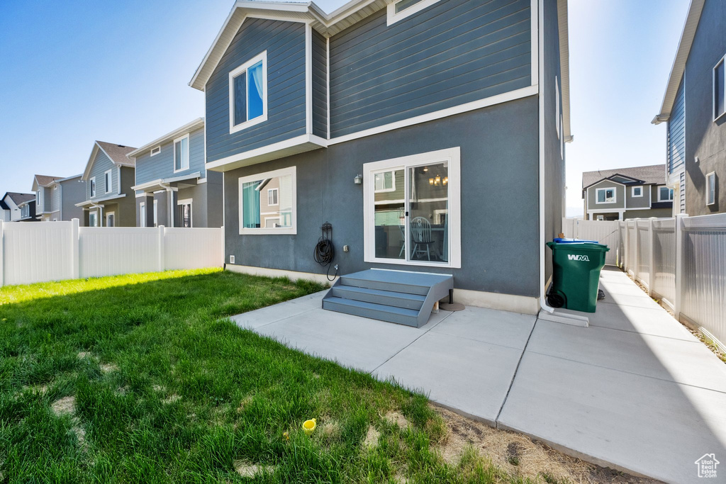 Back of property featuring stucco siding, a patio area, and a residential view
