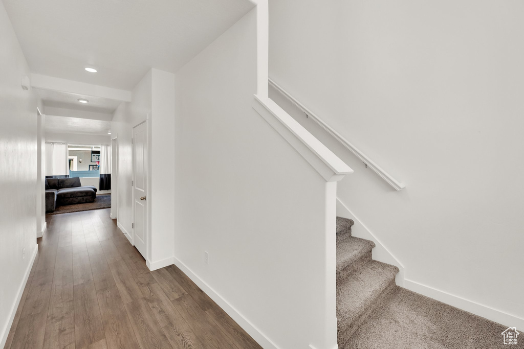 Staircase with recessed lighting, baseboards, and wood finished floors