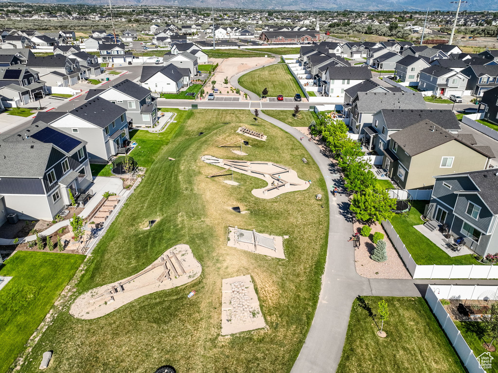 Aerial view of property and surrounding area featuring nearby suburban area