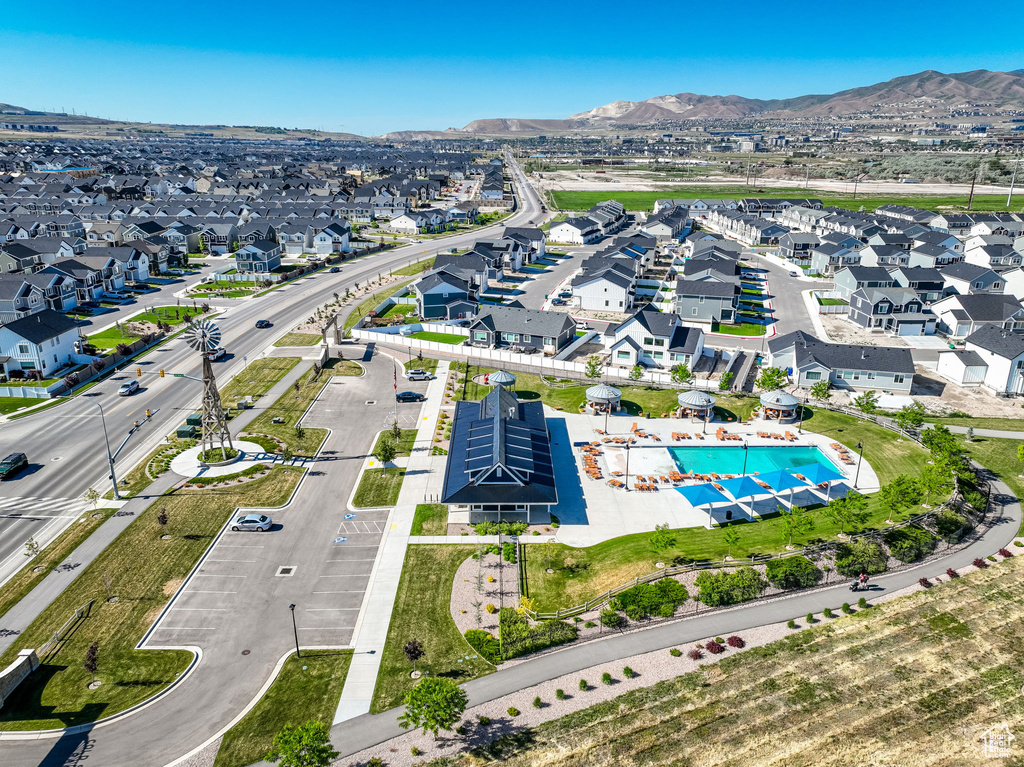 Aerial view of residential area with a pool and mountains