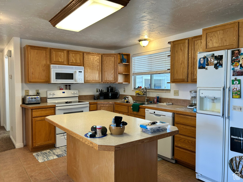 Kitchen with white appliances, a sink, light tile patterned flooring, light countertops, and open shelves