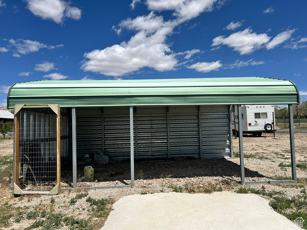 View of outdoor structure with a detached carport