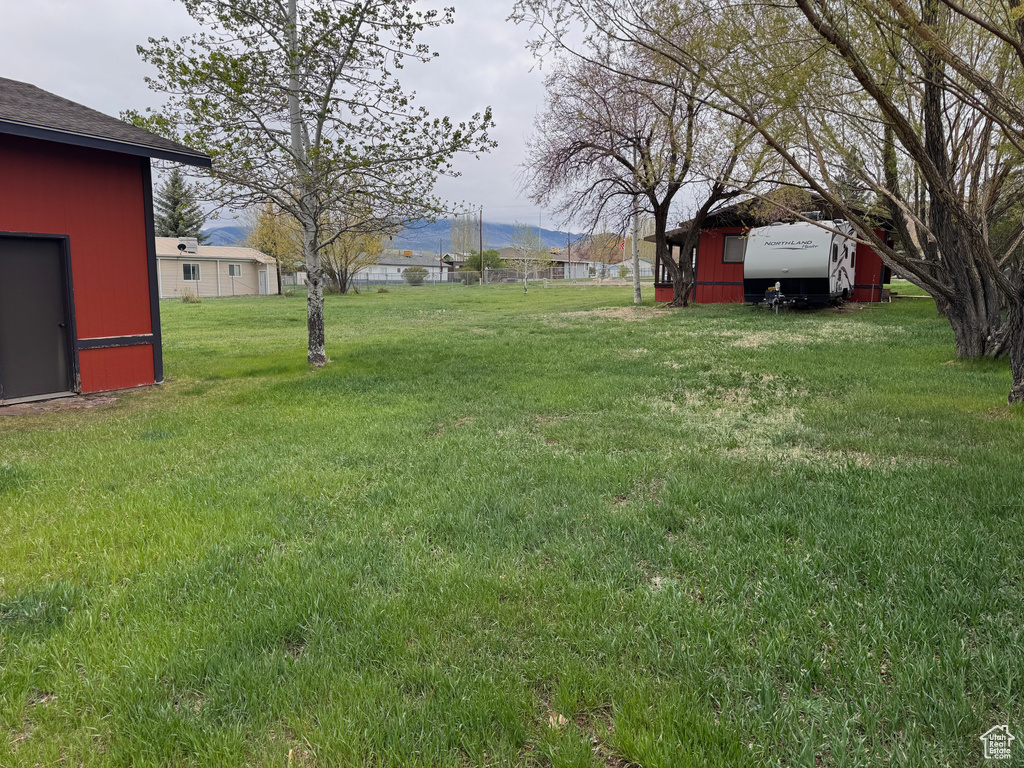 View of grassy yard with a mountain view