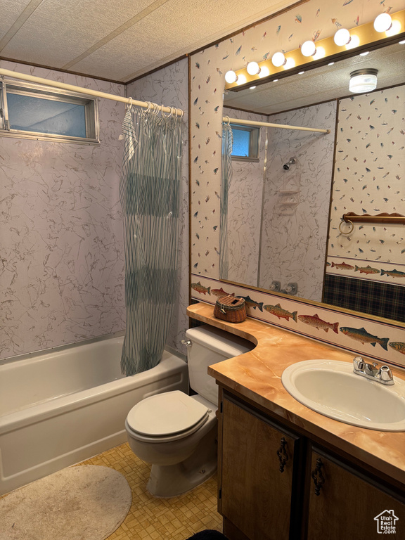 Full bathroom with shower / bath combo, wallpapered walls, vanity, toilet, and a textured ceiling