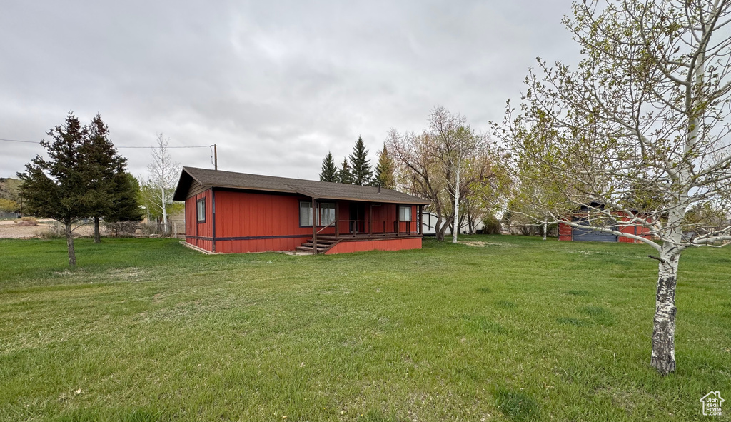 Rear view of house featuring a lawn