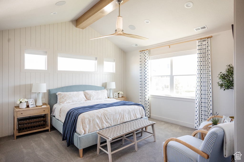 Bedroom featuring light carpet and multiple windows