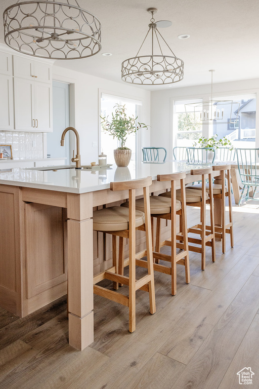 Dining space with light wood-style flooring and recessed lighting