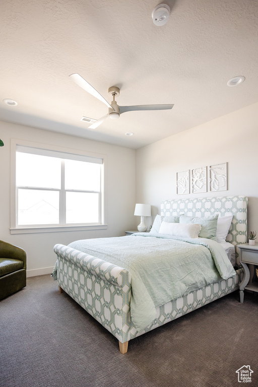 Bedroom featuring carpet floors, a ceiling fan, baseboards, recessed lighting, and a textured ceiling