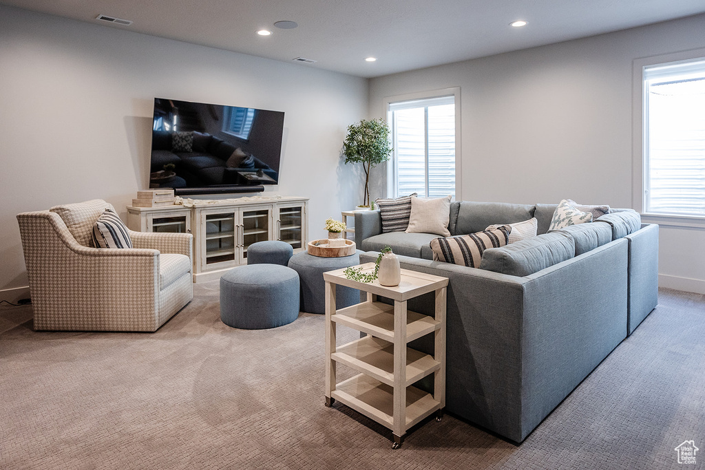 Living room featuring light colored carpet and recessed lighting