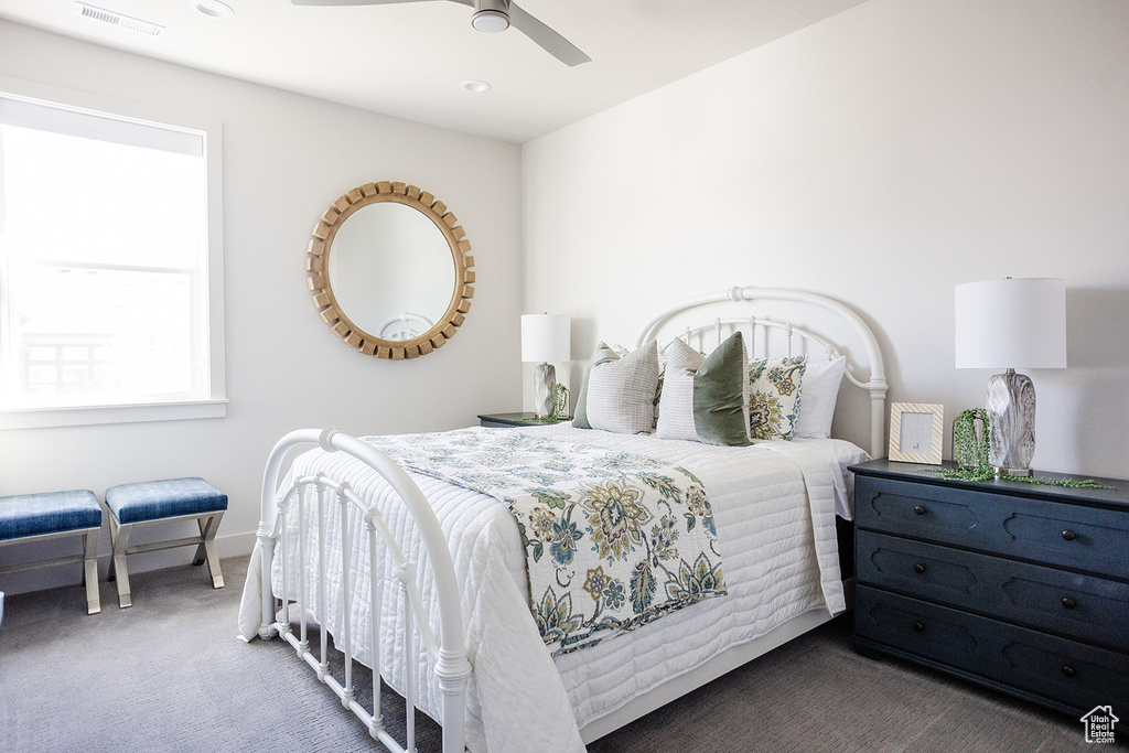 Carpeted bedroom featuring ceiling fan and recessed lighting