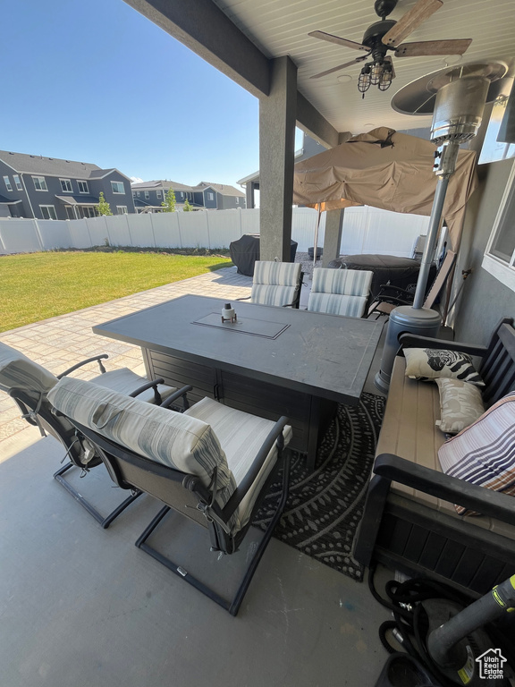 View of patio / terrace featuring a jacuzzi, ceiling fan, a residential view, and an outdoor living space