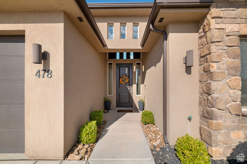 Doorway to property with stucco siding and stone siding