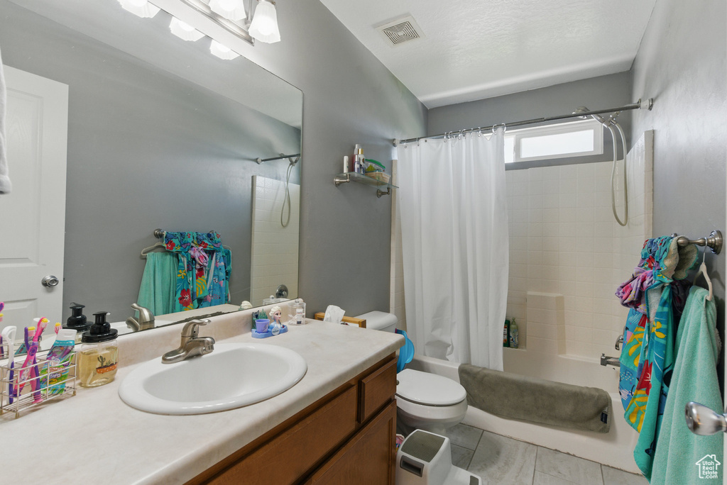 Full bath featuring shower / bathtub combination with curtain, vanity, and toilet