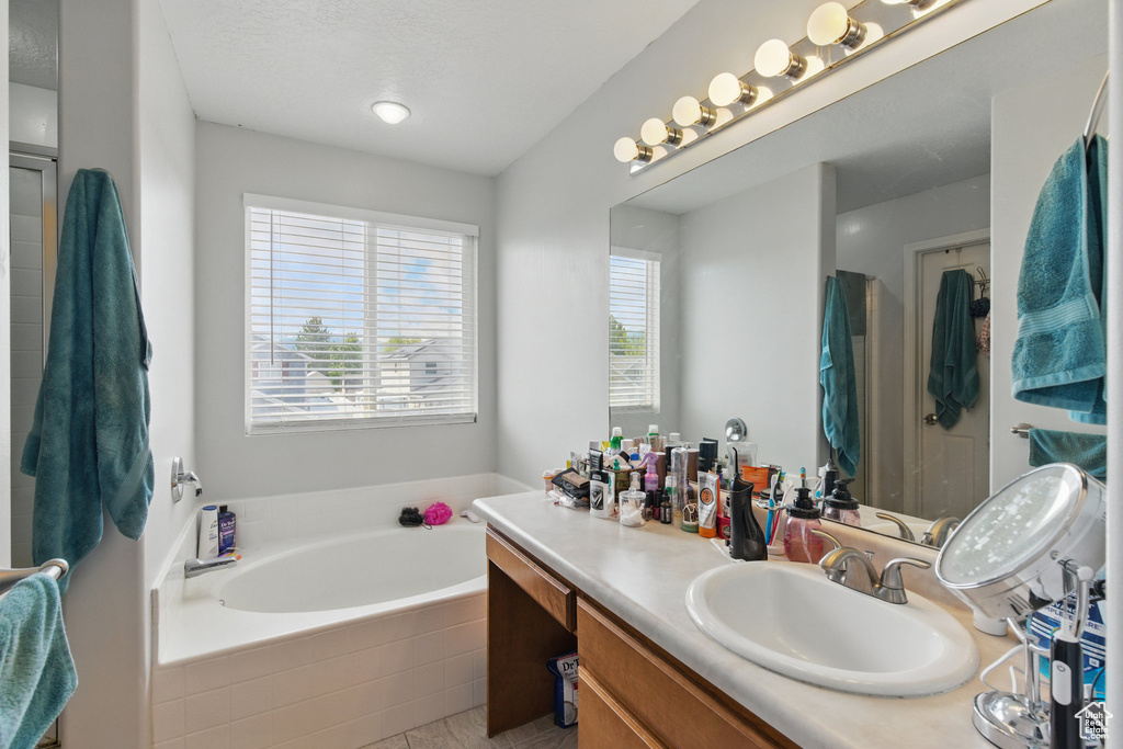 Bathroom with a bath and vanity