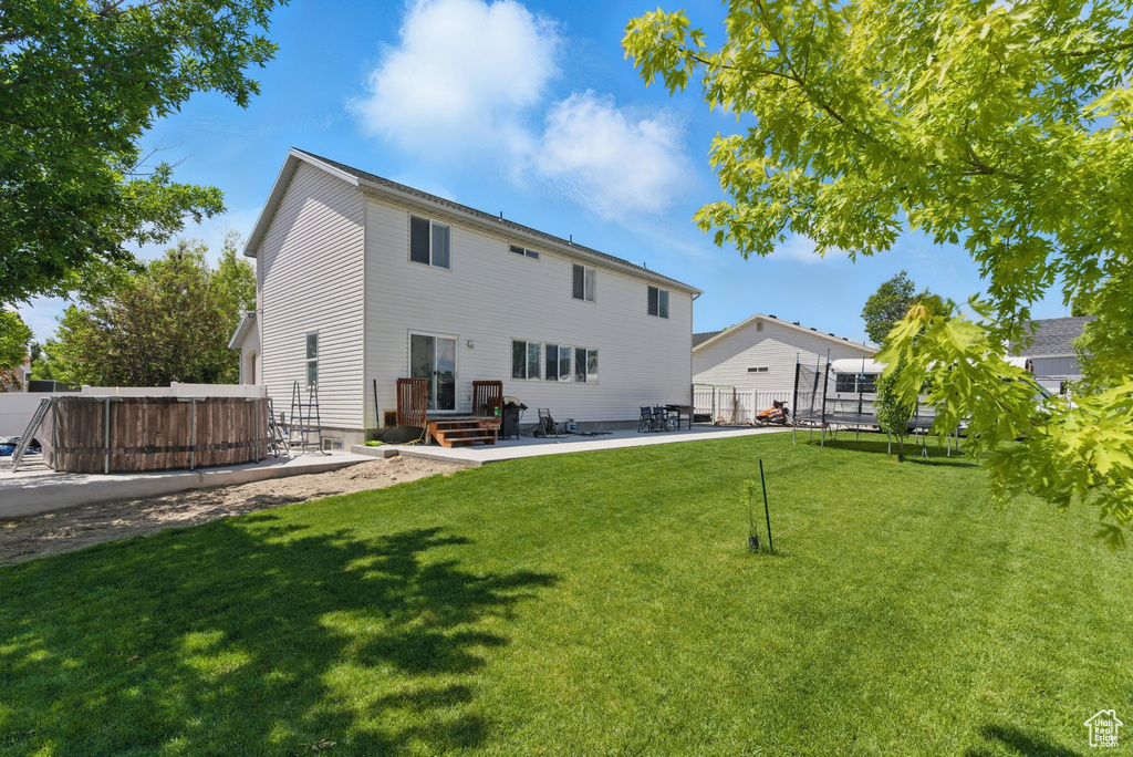 Back of house with a patio area
