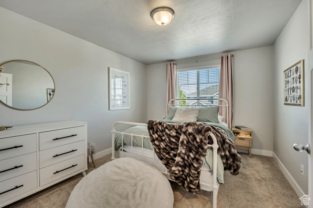 Carpeted bedroom featuring baseboards