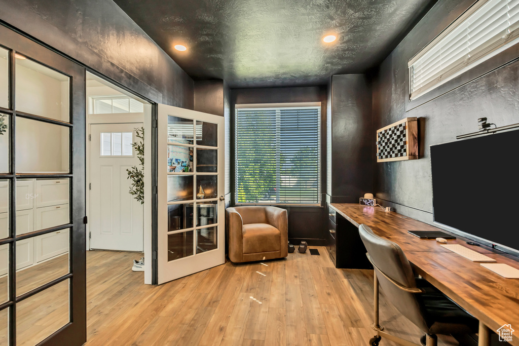 Office area with light wood-type flooring and recessed lighting