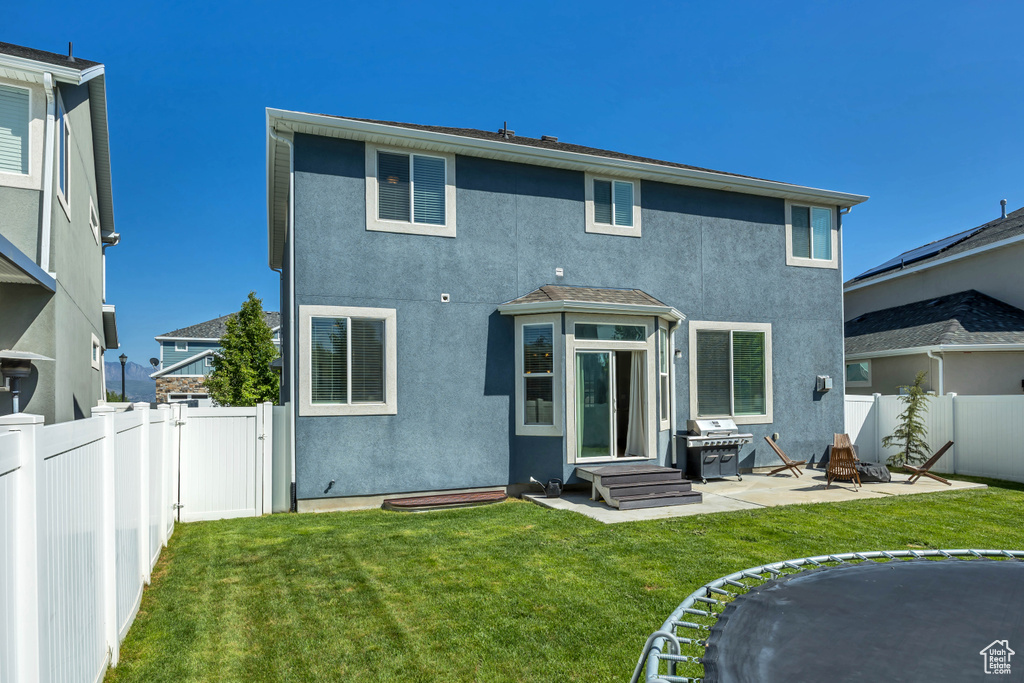 Rear view of property with stucco siding and a patio