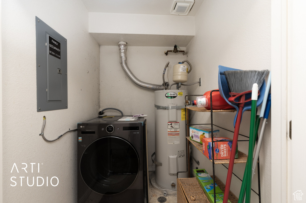 Laundry area featuring electric water heater, washer / clothes dryer, and electric panel