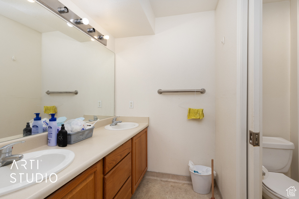 Full bath with double vanity and toilet