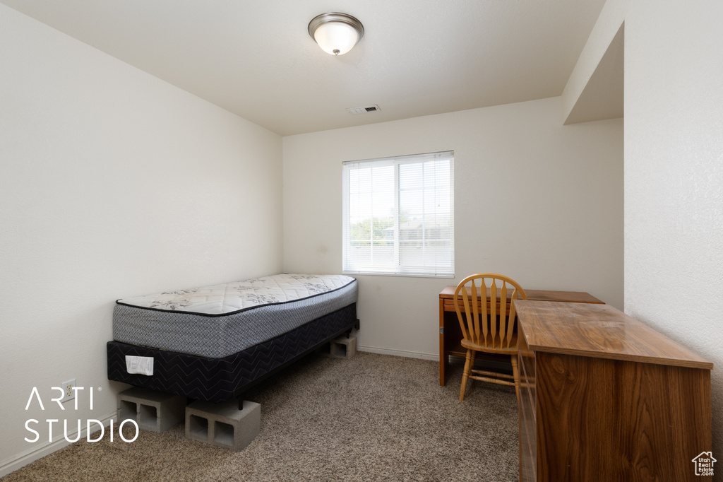 Bedroom featuring carpet flooring and baseboards