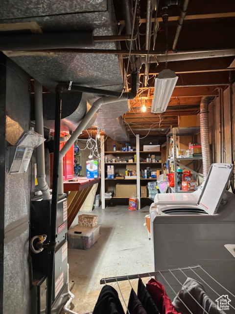 Unfinished below grade area with washer and clothes dryer