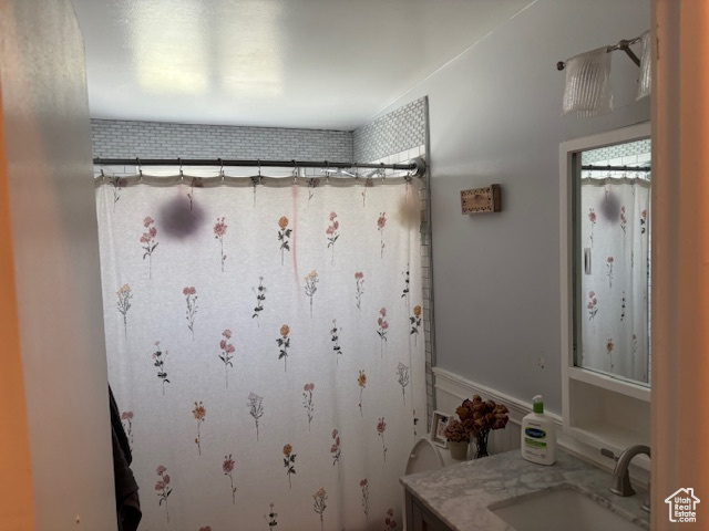 Bathroom featuring vanity and a shower with curtain