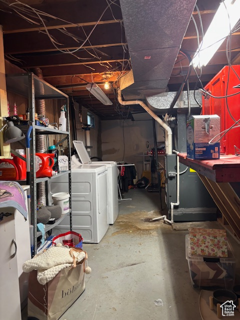 Unfinished below grade area with washing machine and dryer