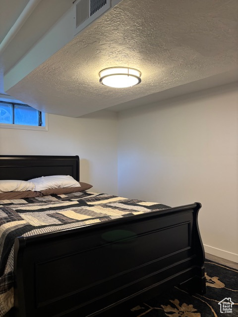 Bedroom featuring a textured ceiling