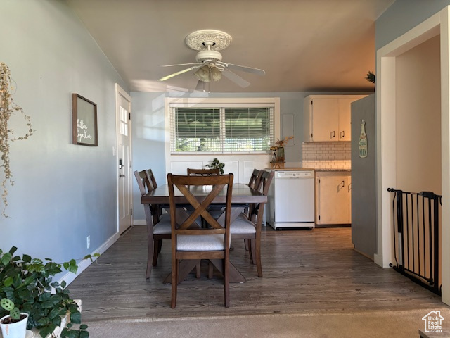 Dining room with ceiling fan and dark wood-style floors