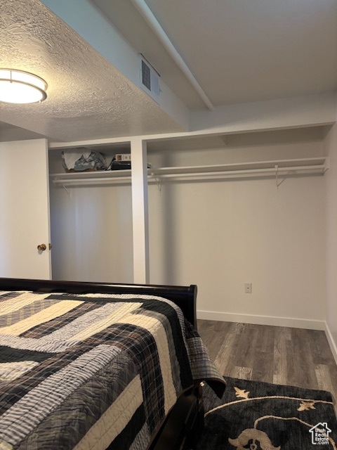 Bedroom featuring wood finished floors and baseboards