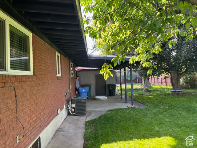 View of yard featuring cooling unit and a patio