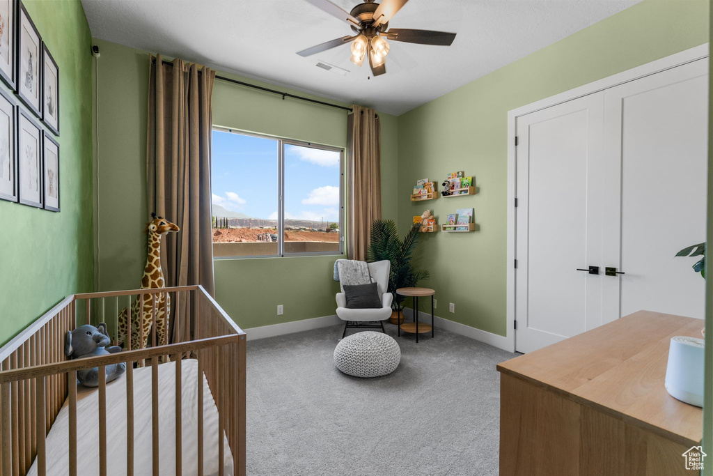 Bedroom featuring carpet, baseboards, and ceiling fan