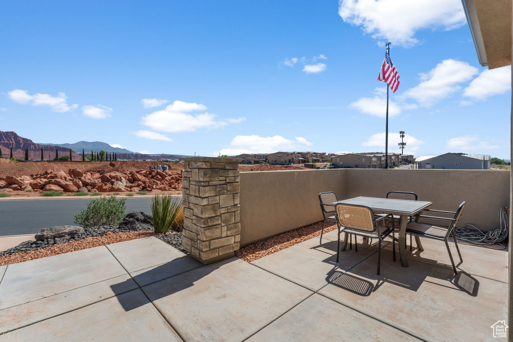 View of patio with a mountain view and outdoor dining space