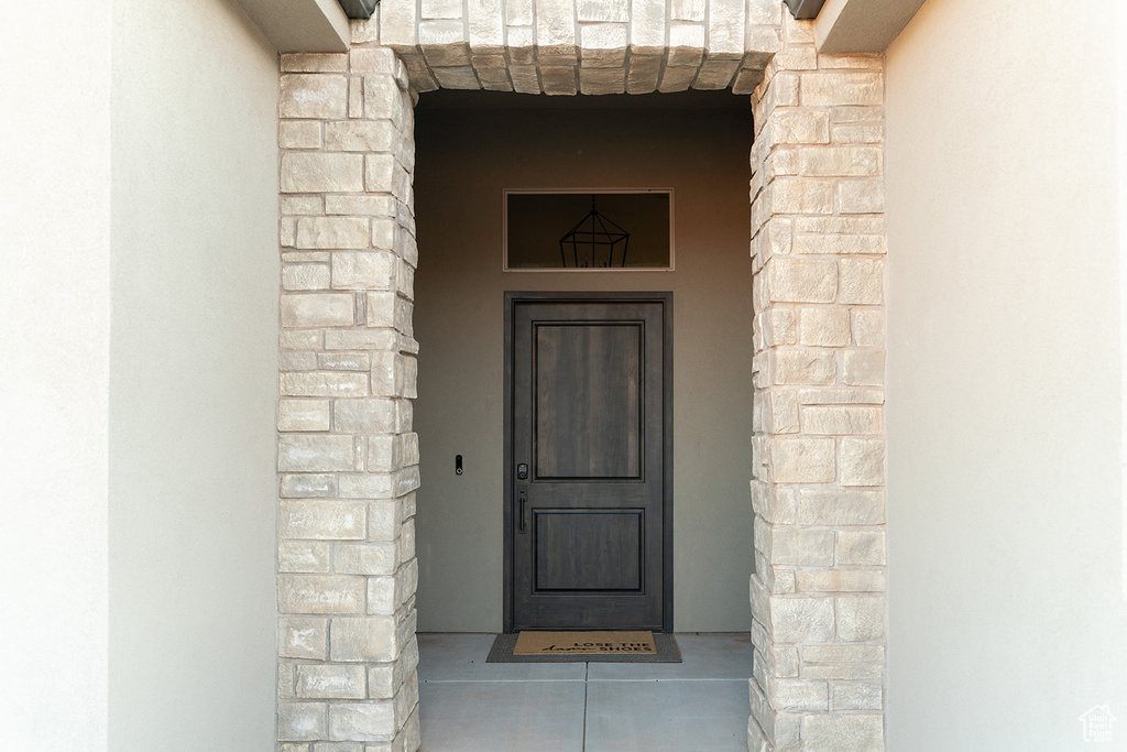 View of exterior entry featuring stone siding