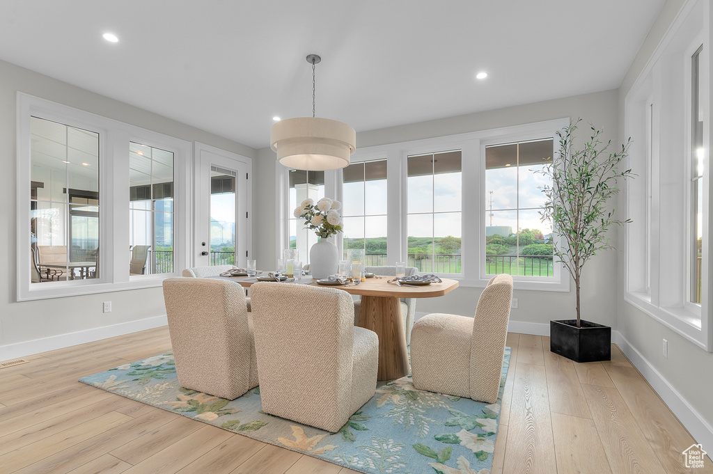 Dining space featuring wood finished floors, baseboards, and recessed lighting