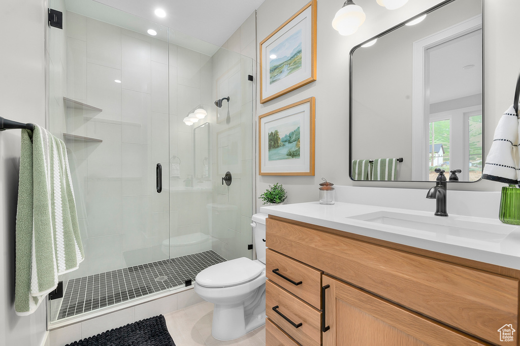 Full bathroom with toilet, a stall shower, vanity, and tile patterned floors
