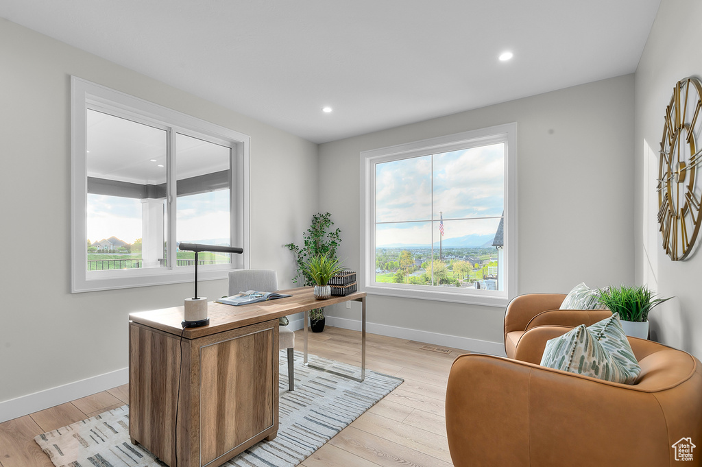 Home office featuring baseboards, light wood-style floors, and recessed lighting