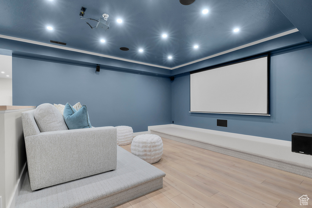 Home theater room with wood finished floors and recessed lighting