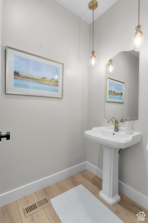 Bathroom featuring baseboards and wood finished floors